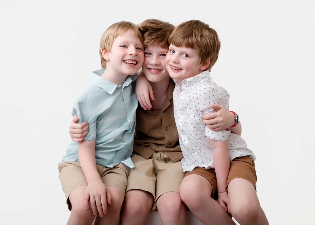 Studio portrait of three brothers hugging by Juliette Scott Photography in Perth